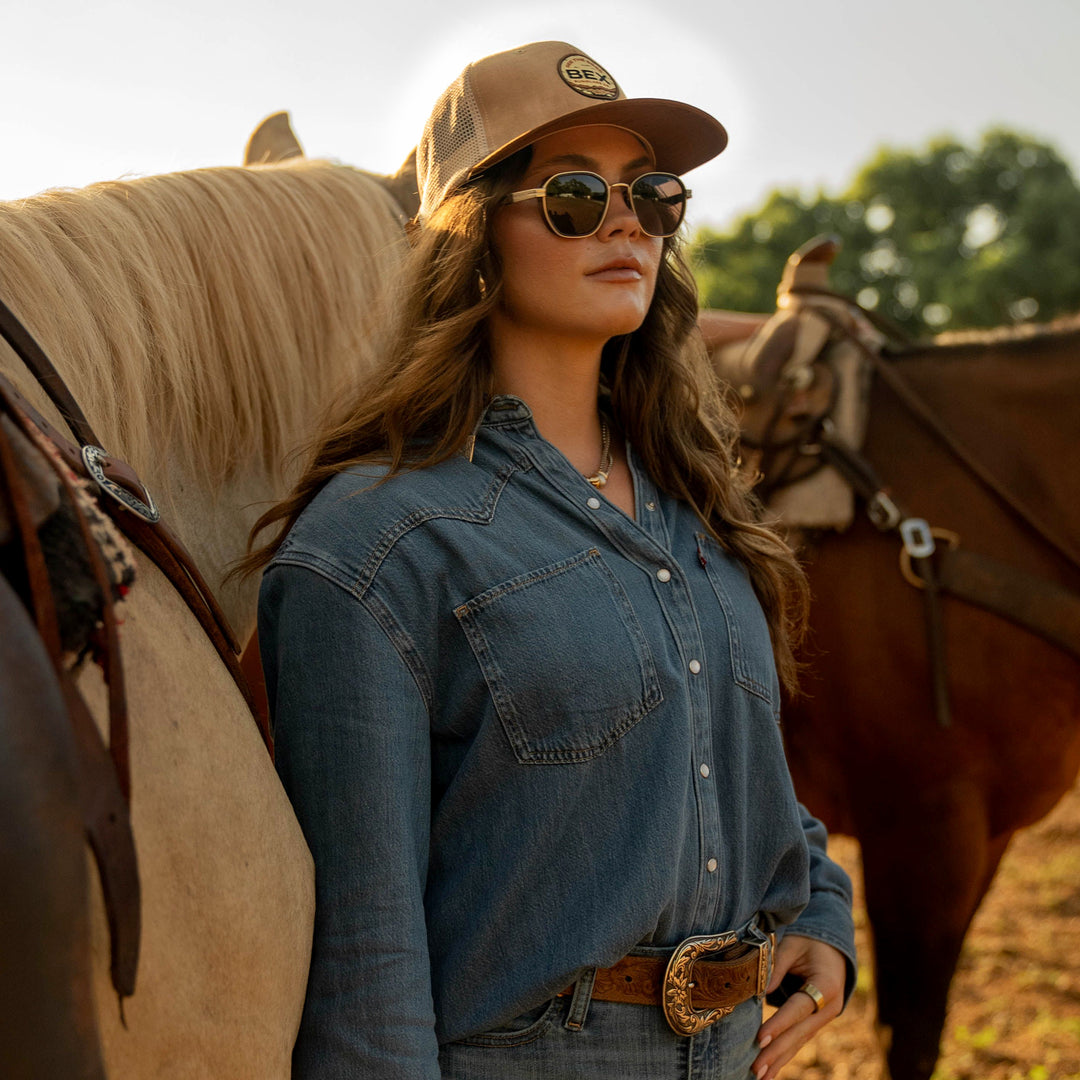 Cowgirl wearing the BEX Sandstone flat bill cap made from corduroy and suede, perfect for cold weather #color_tan-brown